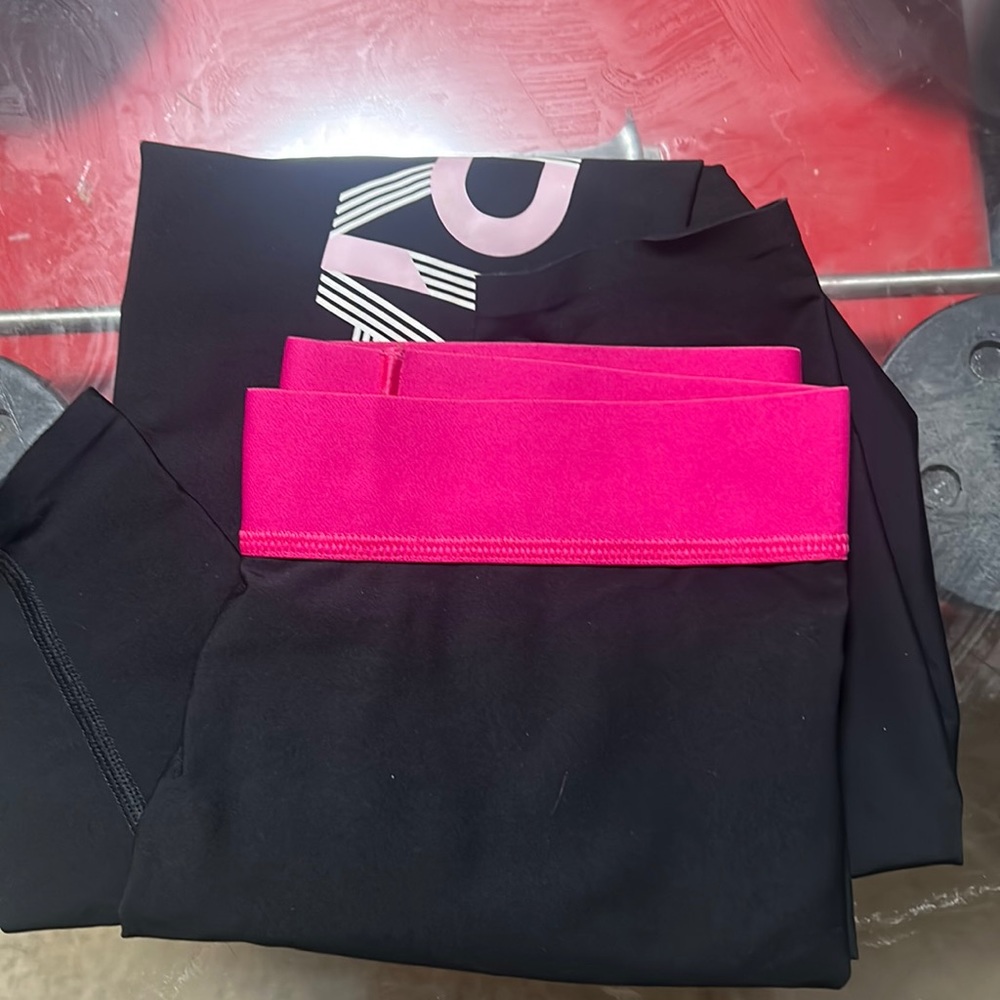 Victoria Secret women’s pink and black leggings.